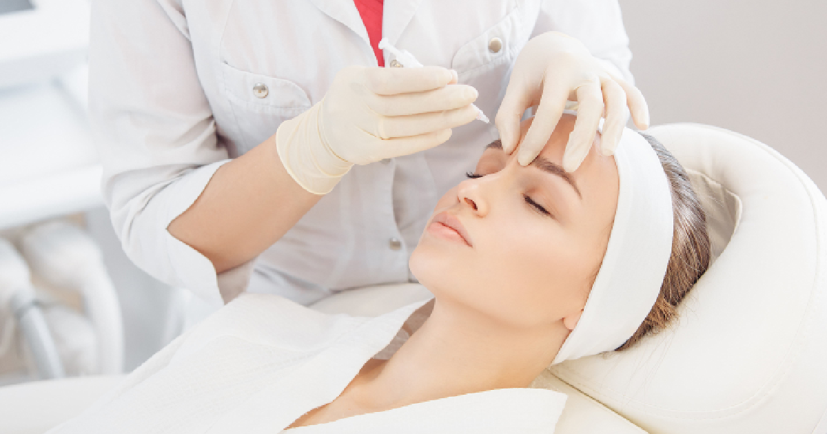 Woman receiving a Neuromodulator from a gloved professional in Stoneham, MA